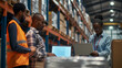 © BB_Stock - Warehouse worker checking inventory or having team meeting with laptop in logistics industry warehouse.