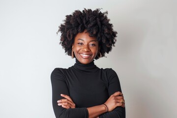 Wall Mural - Portrait of a blissful afro-american woman in her 30s with arms crossed on white background
