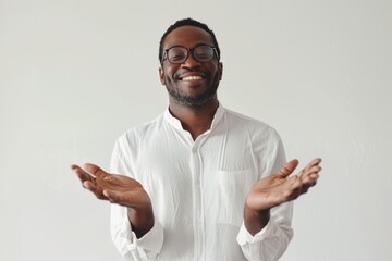Poster - Portrait of a happy man in his 30s joining palms in a gesture of gratitude isolated on white background