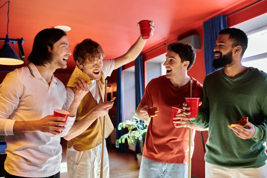 Friends enjoying a game of pool, laughing and snacking.