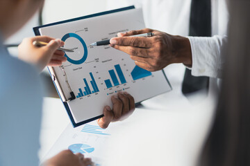 Wall Mural - Business consulting meeting is discussing business plan analysis with financial data and business growth charts to plan strategies for generating company profits.