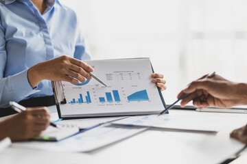 Wall Mural - Business consulting meeting is discussing business plan analysis with financial data and business growth charts to plan strategies for generating company profits.