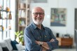 © CogniLens - Portrait of a cheerful man in his 50s with arms crossed on modern minimalist interior
