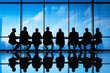 © rabbizz77 - Corporate Leadership Team Strategizing in Modern Boardroom Silhouette
