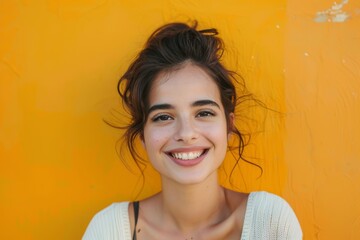 Wall Mural - Portrait of a satisfied woman in her 30s smiling at the camera in front of pastel orange background