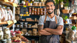 © Vitalii - Portrait of a smiling male seller in apron standing with crossed arms in a coffee shop