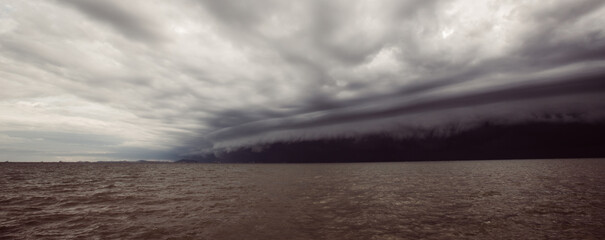 Wall Mural - Cloudy storm in the sea before rainy.tornado storms cloud above the sea. Monsoon season. Storm in the sea.Wonder of natural disaster.Cloud before rain,Sky before the storm.use for background wallpaper