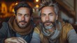 © svastix - A lifestyle portrait capturing two attractive, well-groomed mature men with striking beards, warmly dressed in autumn fashion