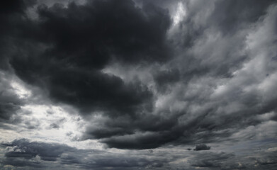 Wall Mural - dark dramatic sky with black stormy clouds before rain as abstract background, extreme weather