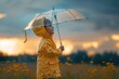 © Fotograf - A young child stands under the open sky, holding onto an umbrella for comfort and protection