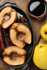 Wall Mural - Tasty baked quinces served with sauce on table, flat lay