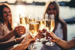 © Людмила Мазур - Two women are holding champagne glasses on a boat, enjoying the sunset. Scene is relaxed and happy