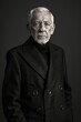 © Sasint - Elderly man modeling a sleek, monochrome outfit, with a sharp haircut to match the contemporary studio setting