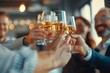 © Ilia Nesolenyi - A close-up shot of a business team raising their glasses in a toast during a celebratory gathering at a restaurant