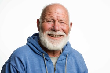 A senior man with a white beard, wearing a blue hoodie, smiles brightly against a white background