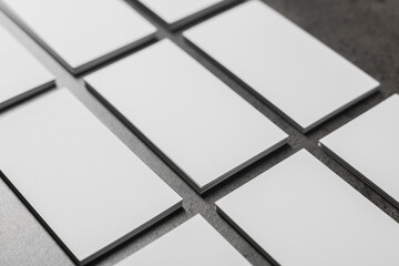 Sticker - Blank business cards on grey textured table, closeup. Mockup for design
