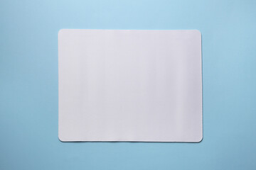 Wall Mural - One mouse pad on light blue background, top view. Space for text