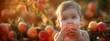 © Viktor - A child happily munches on a peach in front of a bush laden with fruits, sun illuminating her radiant face