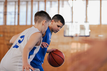 Wall Mural - Close-up of kids with blurred faces playing basketball