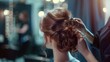 © Jelena - hairdresser creating beautiful hairstyle for young woman at luxury salon hairstyling concept