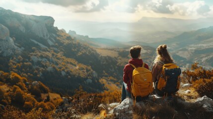 Two people are sitting on a mountain top, looking out at the beautiful landscape