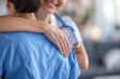 © Konstiantyn Zapylaie - A healthcare worker embraces a colleague, offering comfort and support in a hospital setting