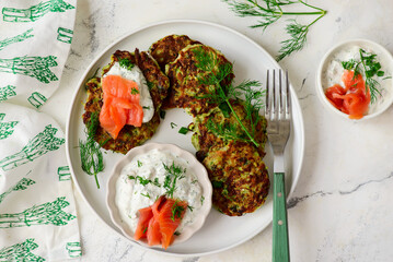 Wall Mural - Zucchini pancakes with sour cream, smoked salmon and dill sauce.top veiw