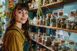 © zgurski1980 - Portrait of a happy woman in a natural health shop with dried mushrooms and herbs, surrounded by glass jars, natural daylight