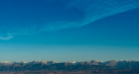 Poster - Panoramic view with high mountains and summer blue sky