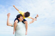 © DG PhotoStock - Asian father and son playing together, a man piggyback the boy on his back.