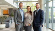 © Axel - Three businesspeople in tailored suits stand confidently in a modern office, showcasing professionalism and teamwork. Soft lighting, sleek decor, and natural light enhance the polished atmosphere.