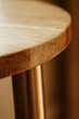© h3design - A close-up image of a wooden tabletop with a subtle grain pattern, bathed in warm, afternoon light