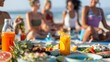 © Justlight - A group of yoga enthusiasts enjoying a healthy brunch on the sand after a morning session on the beach.