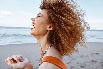 Wall Mural - Beach Bliss: Smiling Woman with Backpack, Radiating Happiness and Freedom in Close-Up Portrait