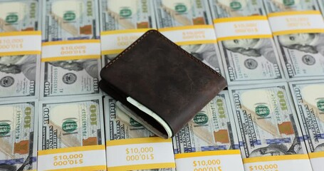 Wall Mural - Woman puts men leather wallet onto American dollar stacks