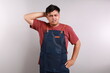 © ArvStd - Young handsome asian man wearing apron standing over white background confuse and wonder about question. Uncertain with doubt, thinking with hand on head. Pensive concept.