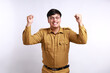 © ArvStd - Excited male worker wearing brown uniform raised his arm. pegawai negeri sipil indonesian government employees