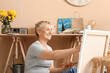 © Pixel-Shot - Mature female artist painting picture in  workshop