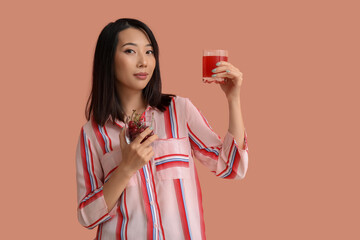 Sticker - Beautiful Asian woman with cherries and glass of juice on pink background