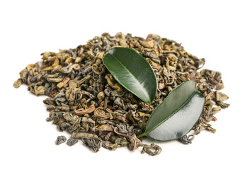 Wall Mural - Heap of dry green tea and fresh leaves on white background