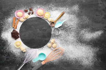 Wall Mural - Frame made of sprinkled flour, raw croissants, ingredients and utensils on dark background