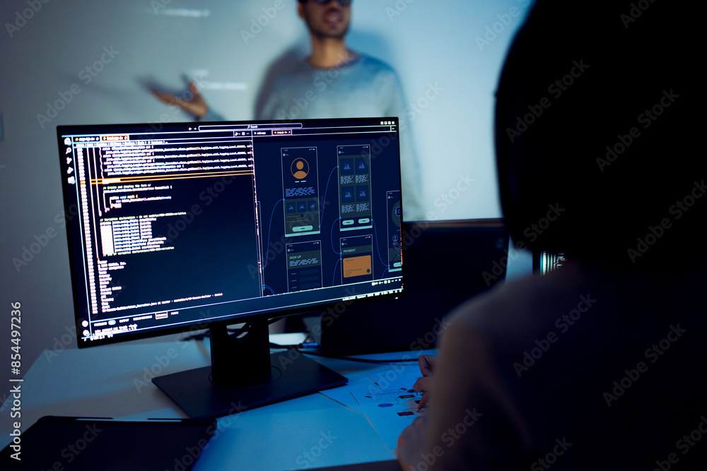asian developer leads present code review session, pointing at code projected on the wall with colleagues  teamwork and knowledge sharing in software development.