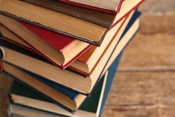 Wall Mural - Stack of old hardcover books on wooden background, closeup