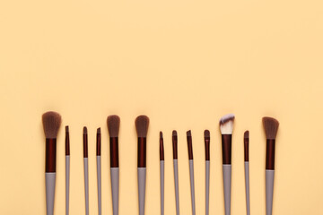 Wall Mural - Makeup brushes on yellow background