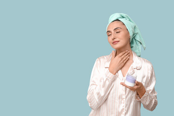 Poster - Young woman with jar of cream on blue background