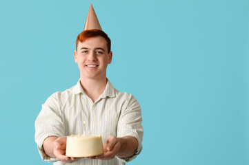 Sticker - Young man in party hat with sweet cake celebrating Birthday on blue background