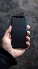 Wall Mural - Mockup image of a hand holding a black smartphone with a blank black screen in a blurred background.Generative AI