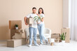 © Pixel-Shot - Young happy couple with belongings in their new house