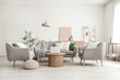 © Pixel-Shot - Stylish interior of living room with cozy sofa, armchairs, coffee table, laptop and olive tree