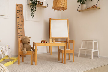 Sticker - Interior of light playroom with toys, rocking horse and whiteboard in kindergarten